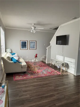 a bedroom with furniture and a wooden floor