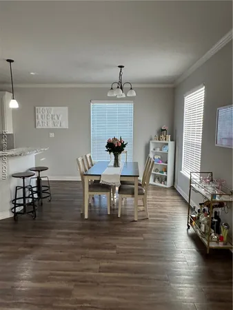 a dining room with furniture and wooden floor