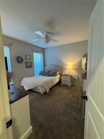 a bedroom with a bed and a mirror