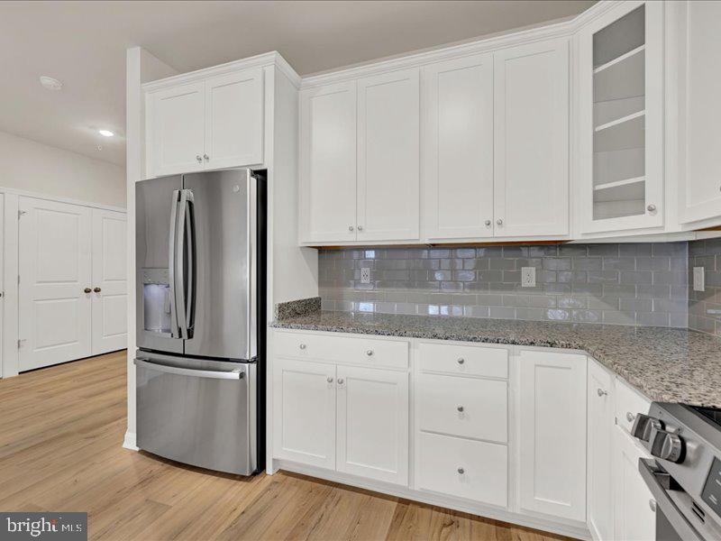4005 Seaside Alder Road, Unit D Bowie, MD 20720 - Photo 12 of 41 a kitchen with granite countertop white cabinets and stainless steel appliances