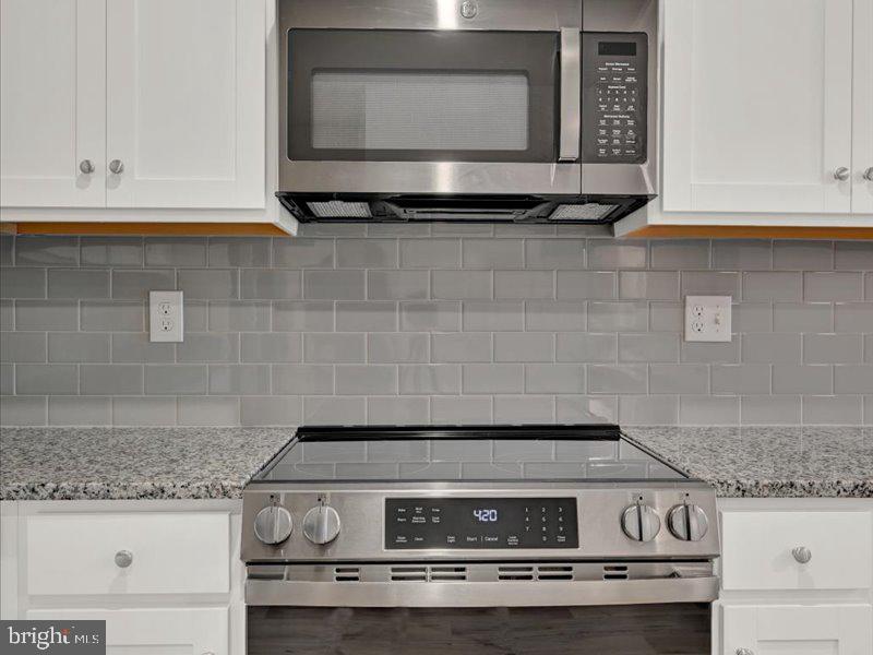 4005 Seaside Alder Road, Unit D Bowie, MD 20720 - Photo 15 of 41 a stove top oven sitting inside of a kitchen