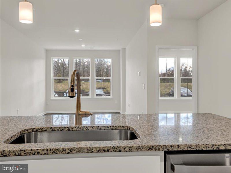 4005 Seaside Alder Road, Unit D Bowie, MD 20720 - Photo 16 of 41 a kitchen with kitchen island a counter top space appliances and a window