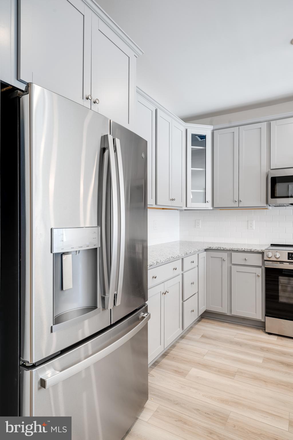 4005 Seaside Alder Road, Unit D Bowie, MD 20720 - Photo 17 of 19 a kitchen with stainless steel appliances and refrigerator