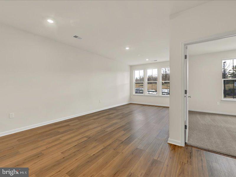 4005 Seaside Alder Road, Unit D Bowie, MD 20720 - Photo 18 of 41 wooden floor in an empty room with a window