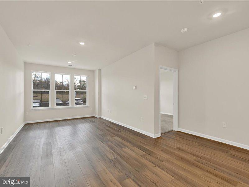 4005 Seaside Alder Road, Unit D Bowie, MD 20720 - Photo 19 of 41 wooden floor in an empty room with a window