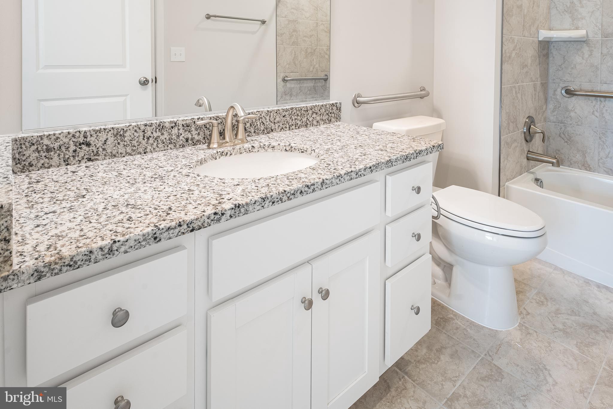 4005 Seaside Alder Road, Unit D Bowie, MD 20720 - Photo 2 of 19 a bathroom with a sink and mirror with toilet