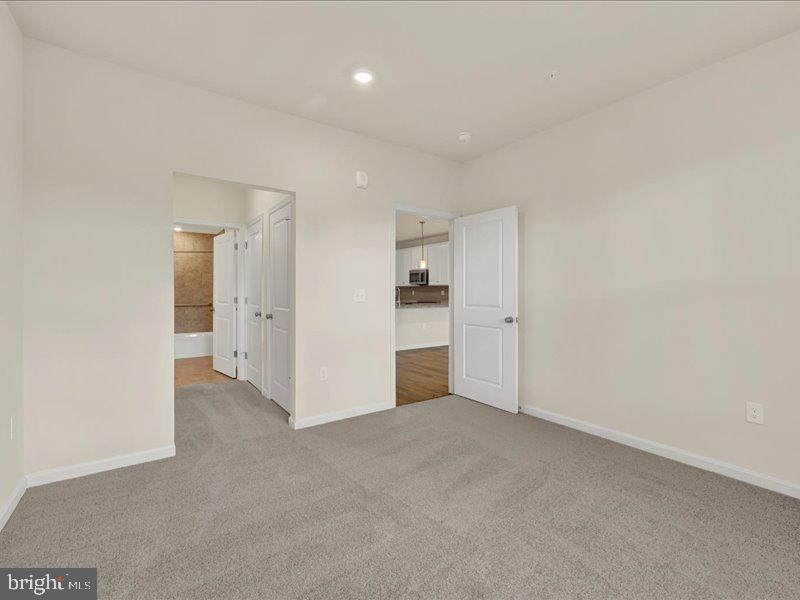 4005 Seaside Alder Road, Unit D Bowie, MD 20720 - Photo 21 of 41 a view of an empty room and a kitchen