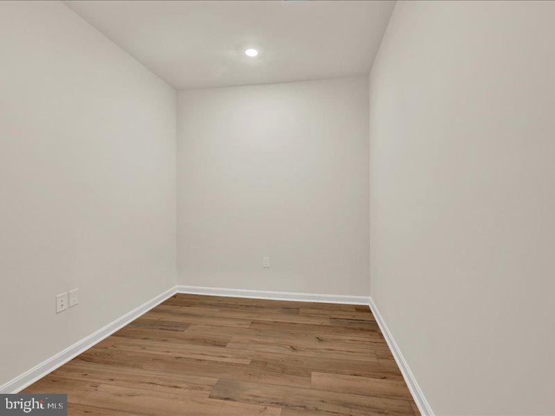 4005 Seaside Alder Road, Unit D Bowie, MD 20720 - Photo 23 of 41 a view of an empty room with wooden floor