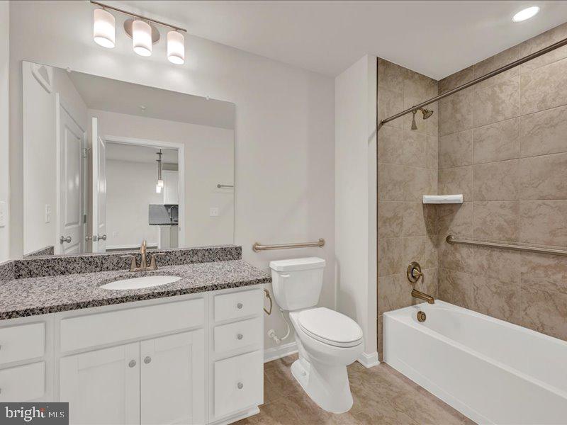 4005 Seaside Alder Road, Unit D Bowie, MD 20720 - Photo 24 of 41 a bathroom with a granite countertop sink a toilet and shower