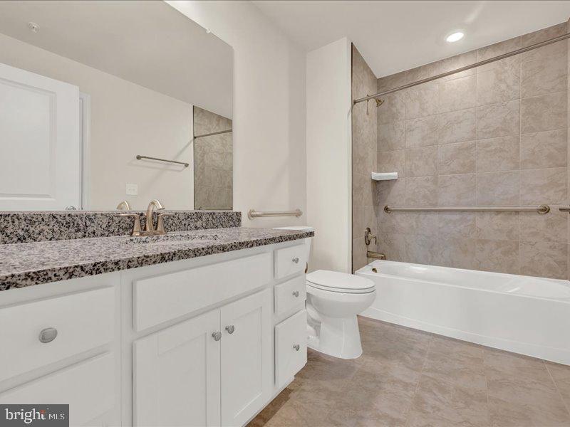 4005 Seaside Alder Road, Unit D Bowie, MD 20720 - Photo 26 of 41 a bathroom with a granite countertop sink a toilet and a bathtub