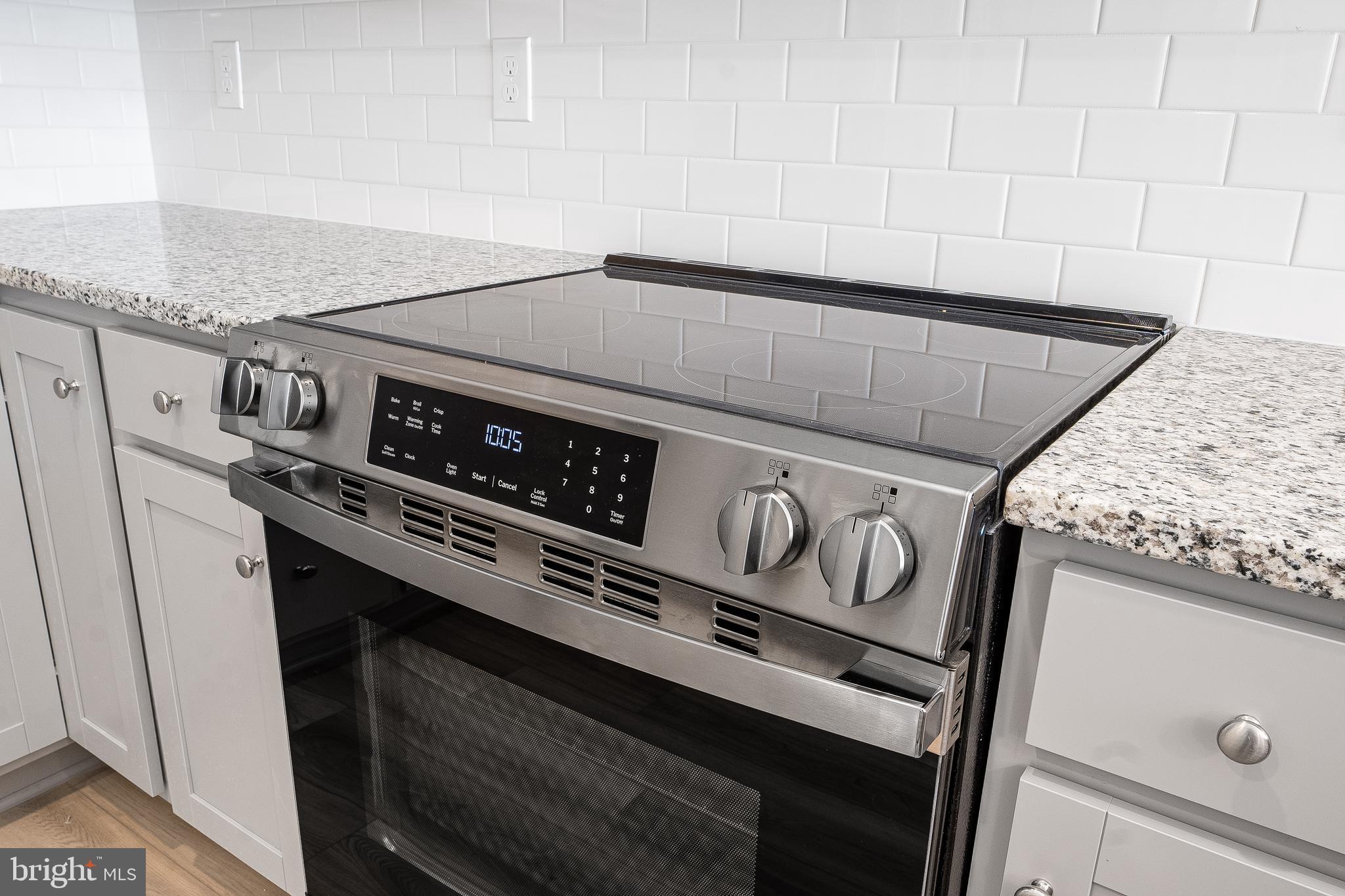 4005 Seaside Alder Road, Unit D Bowie, MD 20720 - Photo 5 of 19 a close up of a stove sitting inside of a kitchen
