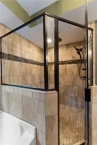 a bedroom with a bed and a dresser next to a window