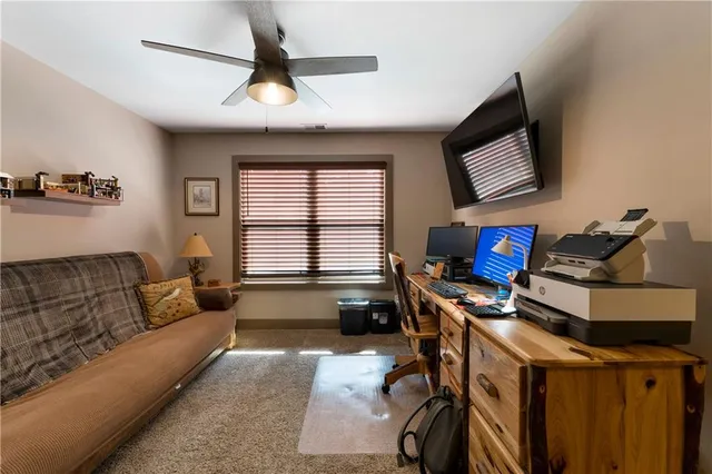 a front view of a house with a garden and trees