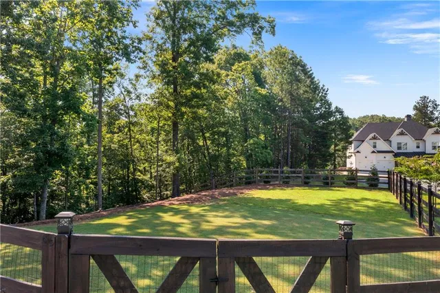 a view of a swimming pool with lawn chairs under an umbrella