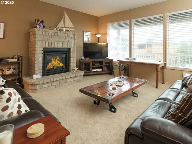 a living room with furniture a flat screen tv and a fireplace