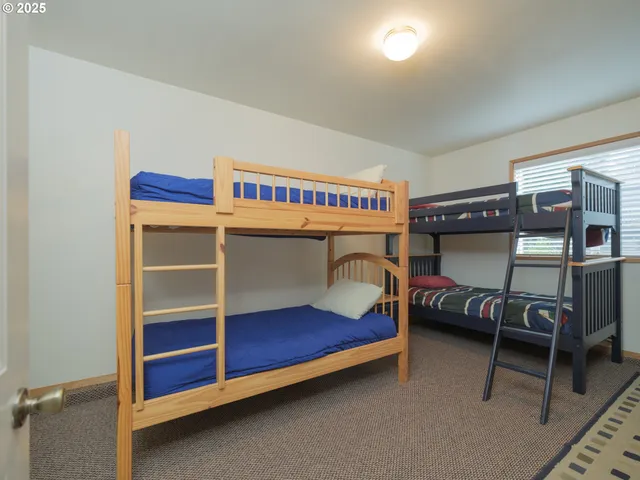 a bedroom with a bed and a desk