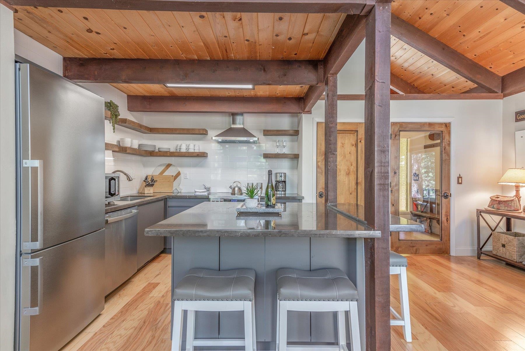 1502 Logging Trail Truckee, CA 96161 - Photo 5 of 21 a kitchen with stainless steel appliances granite countertop a sink and refrigerator