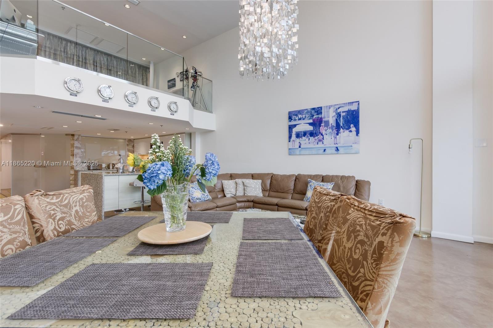 5445 Collins Avenue, Unit P2 Miami Beach, FL 33140 - Photo 14 of 62 a living room with furniture and a chandelier
