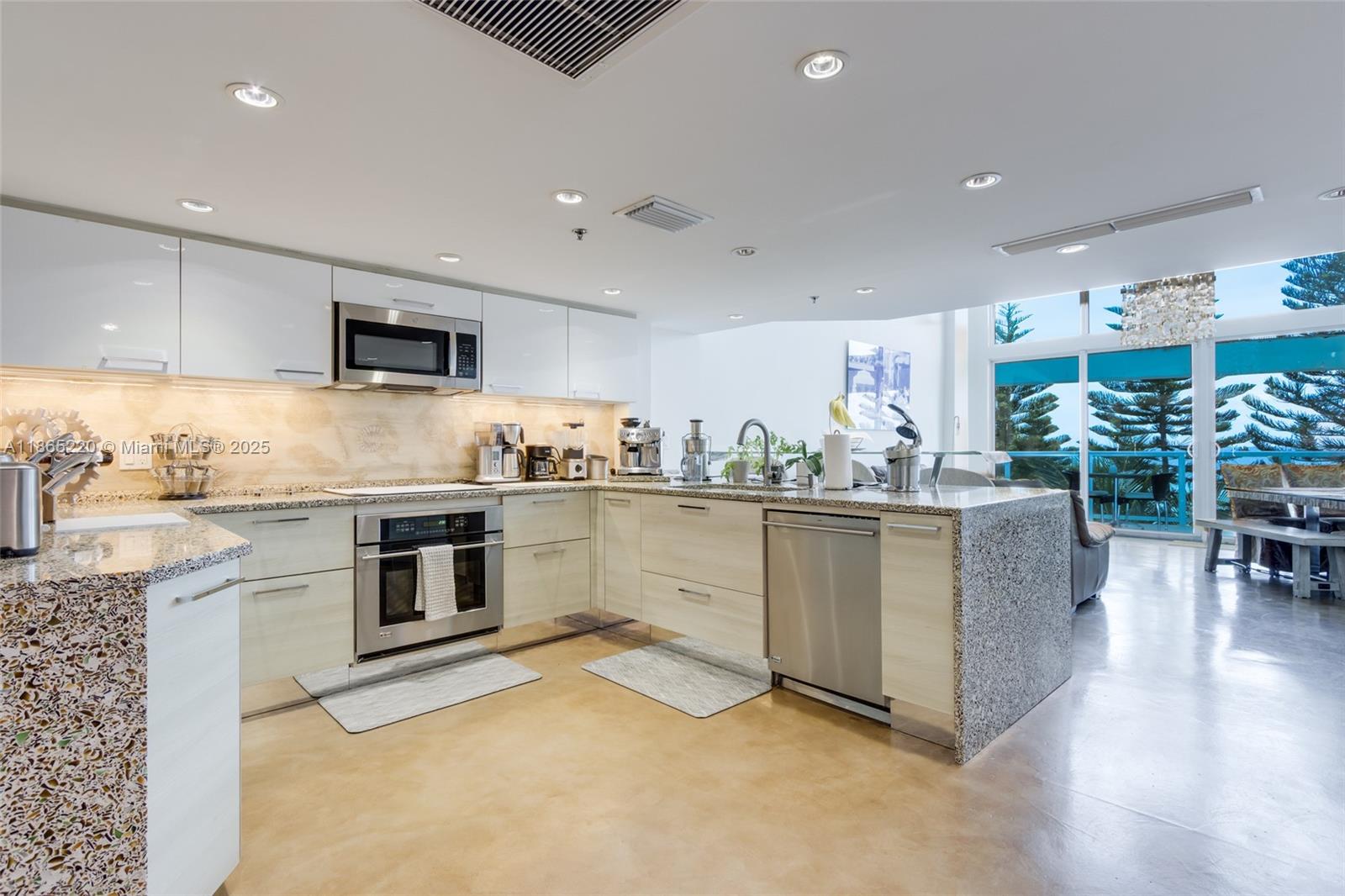 5445 Collins Avenue, Unit P2 Miami Beach, FL 33140 - Photo 16 of 62 a kitchen with white cabinets and appliances