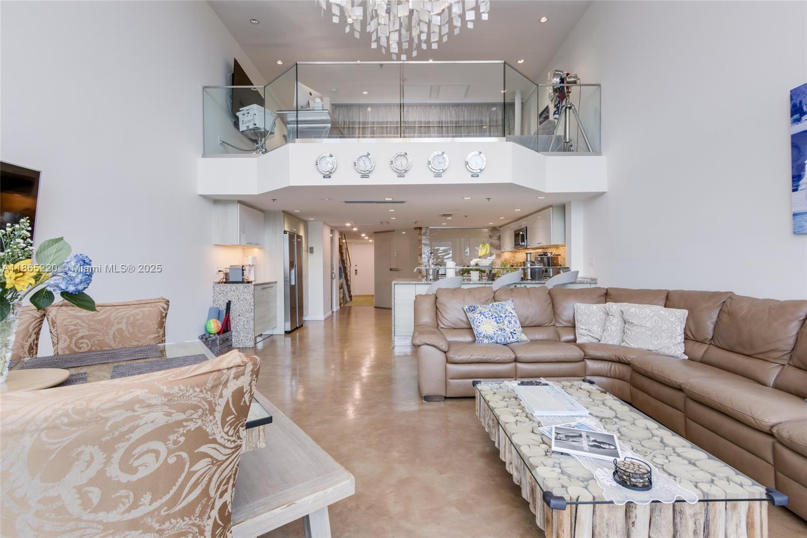 5445 Collins Avenue, Unit P2 Miami Beach, FL 33140 - Photo 18 of 62 a living room with furniture and a chandelier