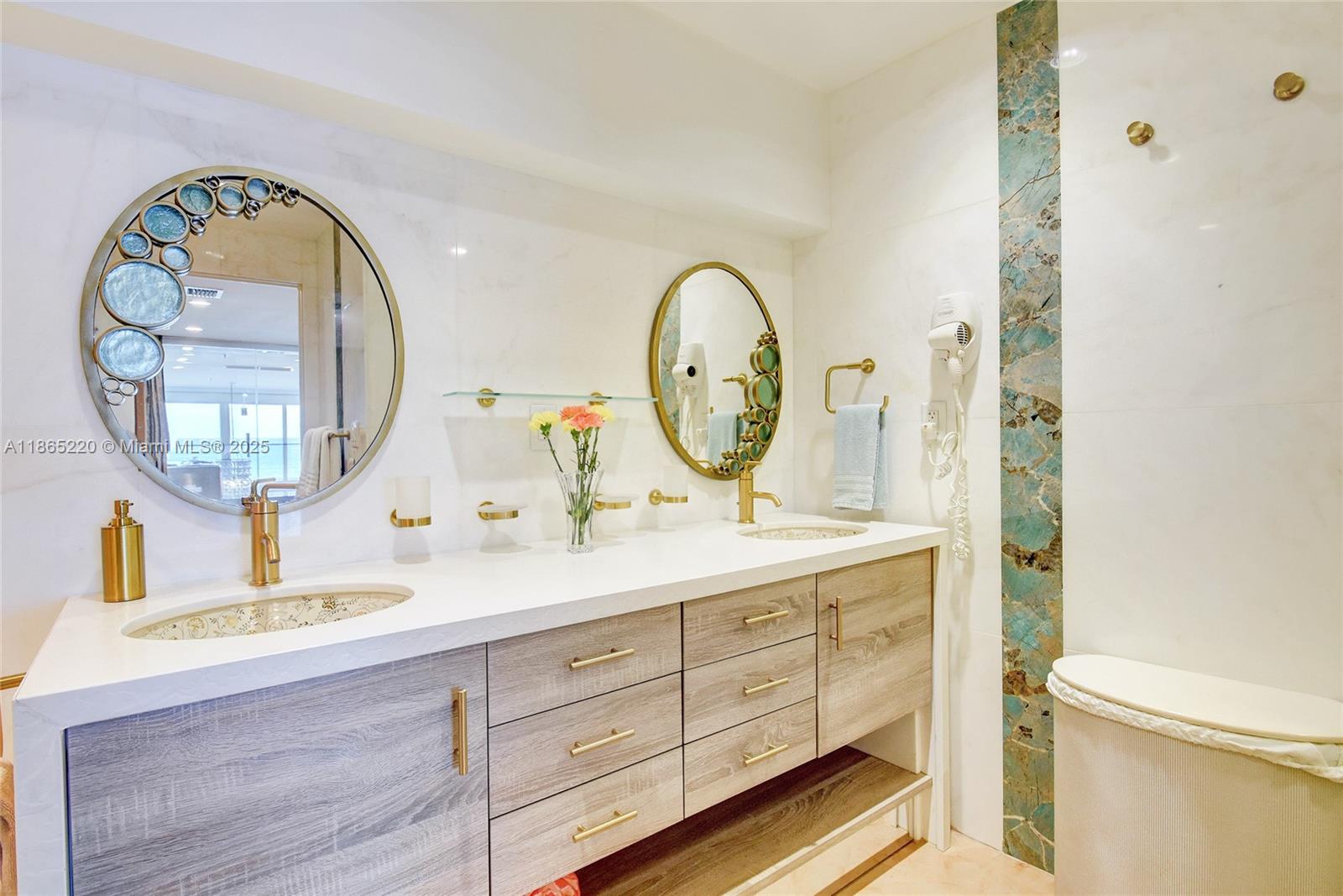 5445 Collins Avenue, Unit P2 Miami Beach, FL 33140 - Photo 26 of 62 a bathroom with a granite countertop double vanity sink and a mirror