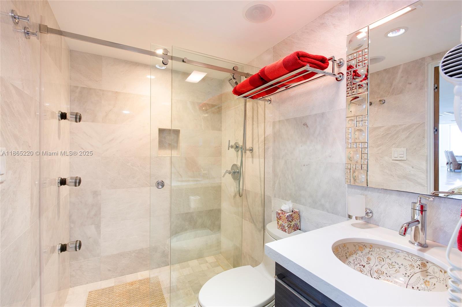 5445 Collins Avenue, Unit P2 Miami Beach, FL 33140 - Photo 27 of 62 a bathroom with a sink and a mirror