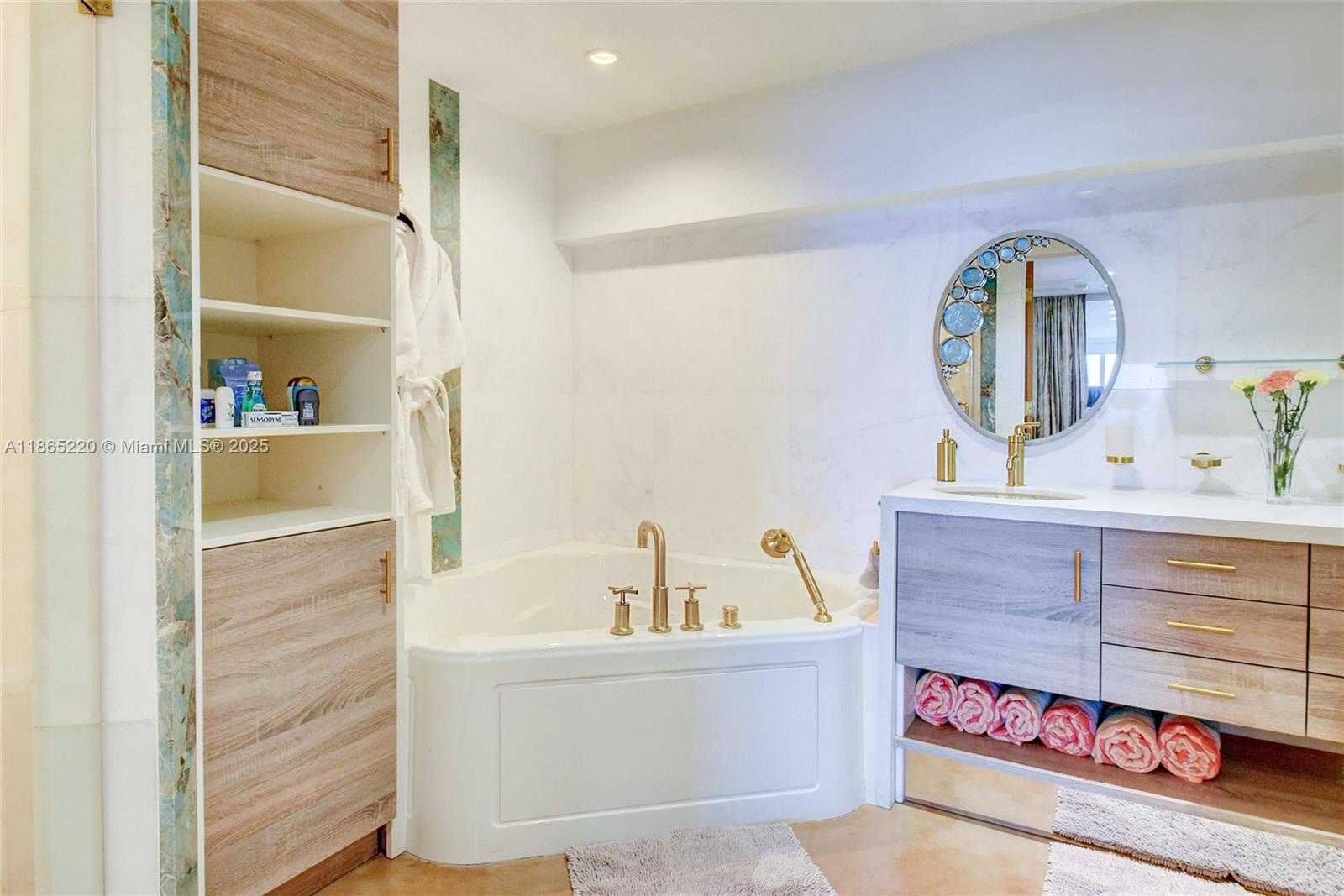 5445 Collins Avenue, Unit P2 Miami Beach, FL 33140 - Photo 31 of 62 a bathroom with a sink and a mirror