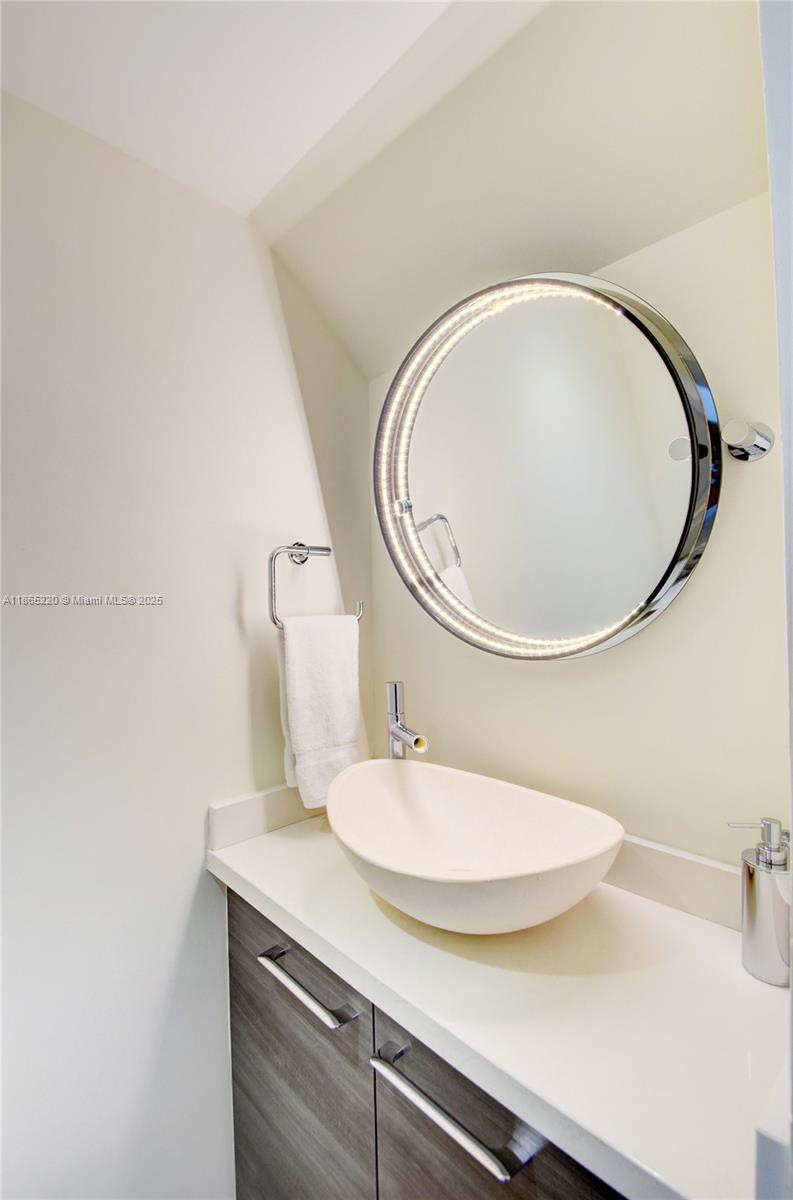5445 Collins Avenue, Unit P2 Miami Beach, FL 33140 - Photo 33 of 62 a bathroom with a sink and a mirror
