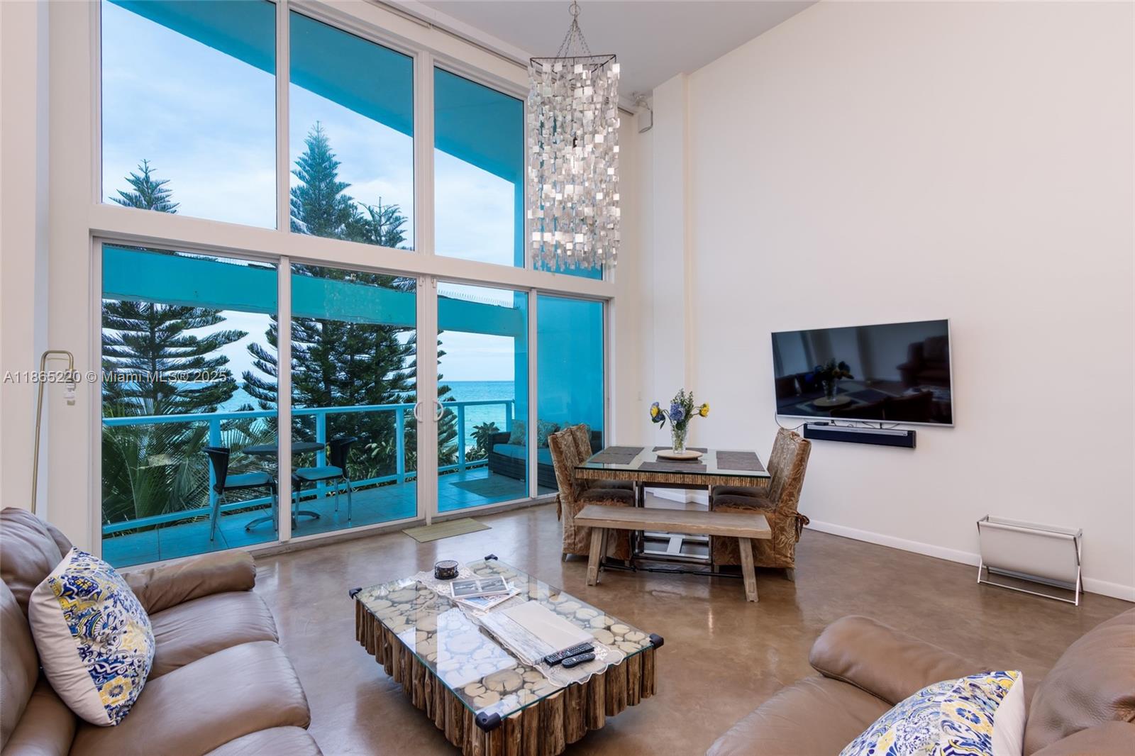 5445 Collins Avenue, Unit P2 Miami Beach, FL 33140 - Photo 45 of 62 a living room with furniture and a flat screen tv