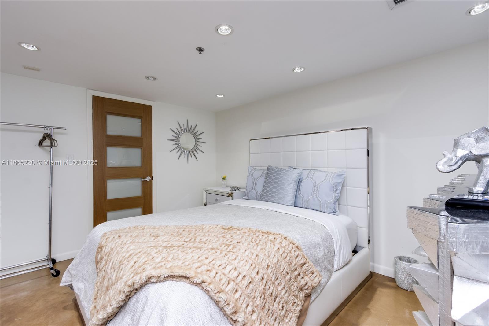 5445 Collins Avenue, Unit P2 Miami Beach, FL 33140 - Photo 48 of 62 a bedroom with a bed and a painting on the wall