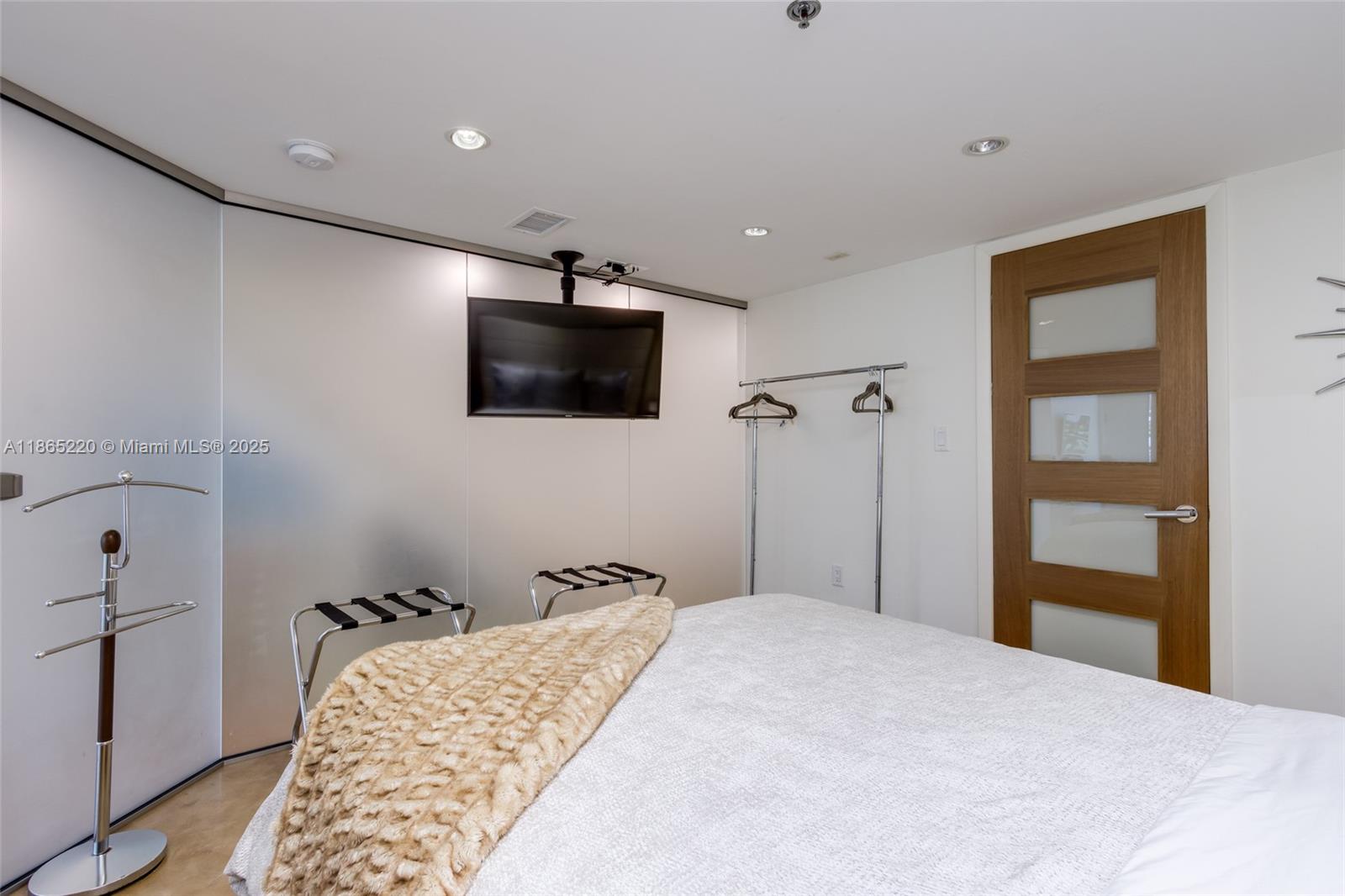 5445 Collins Avenue, Unit P2 Miami Beach, FL 33140 - Photo 49 of 62 a bedroom with a bed and a flat screen tv