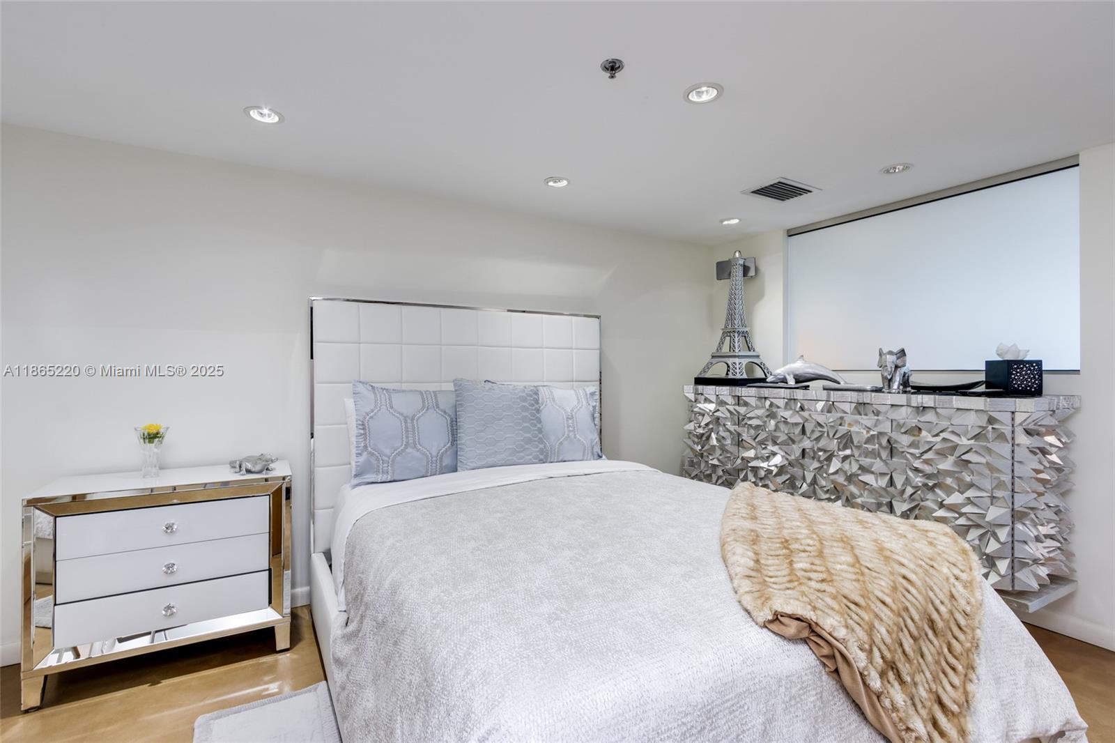 5445 Collins Avenue, Unit P2 Miami Beach, FL 33140 - Photo 50 of 62 a bedroom with a bed and a night stand