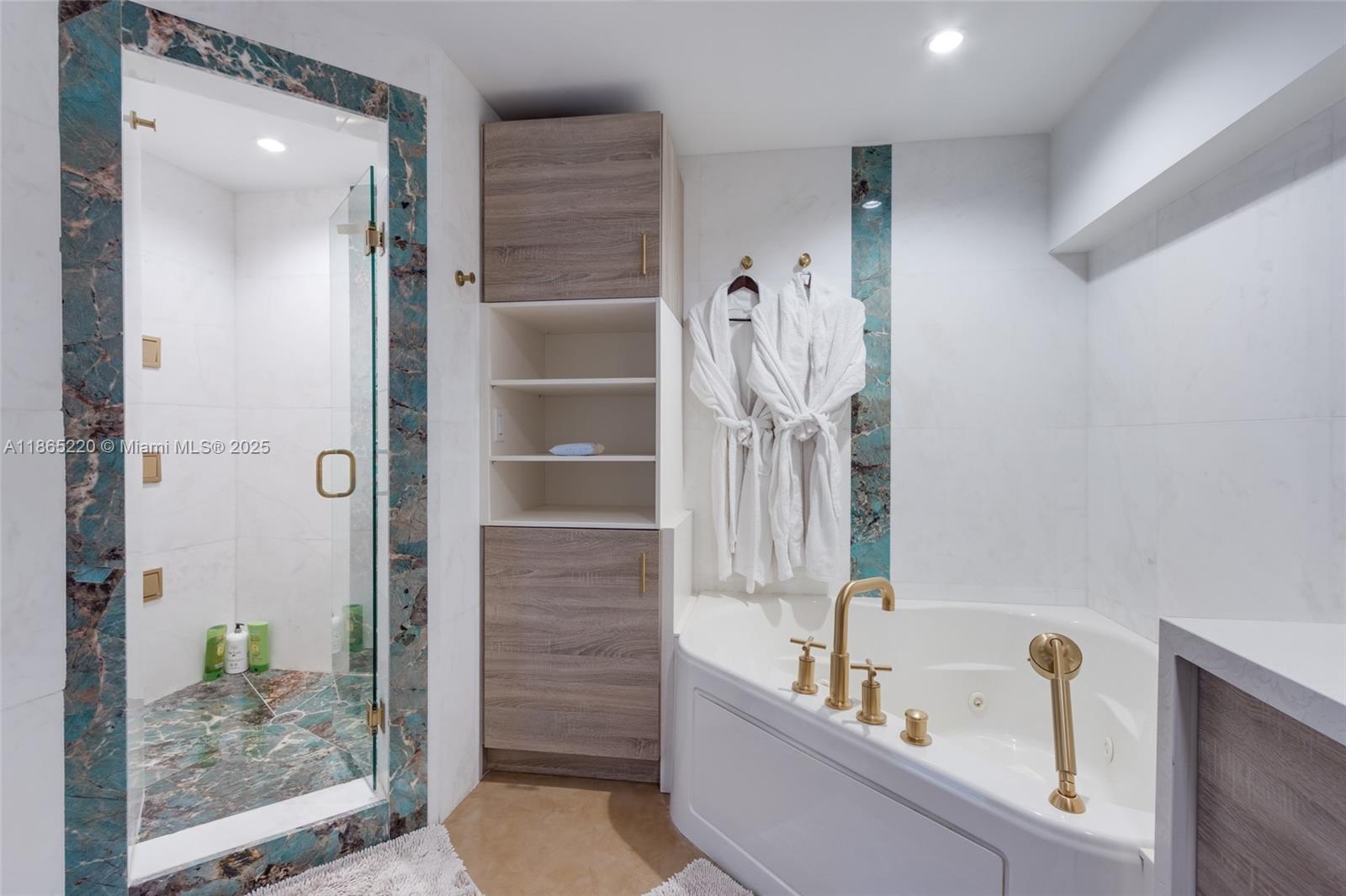 5445 Collins Avenue, Unit P2 Miami Beach, FL 33140 - Photo 59 of 62 a bathroom with a tub a rug and shower