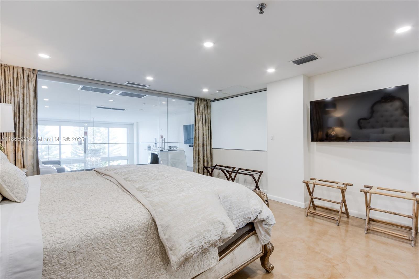 5445 Collins Avenue, Unit P2 Miami Beach, FL 33140 - Photo 60 of 62 a spacious bedroom with a bed a television and a large window