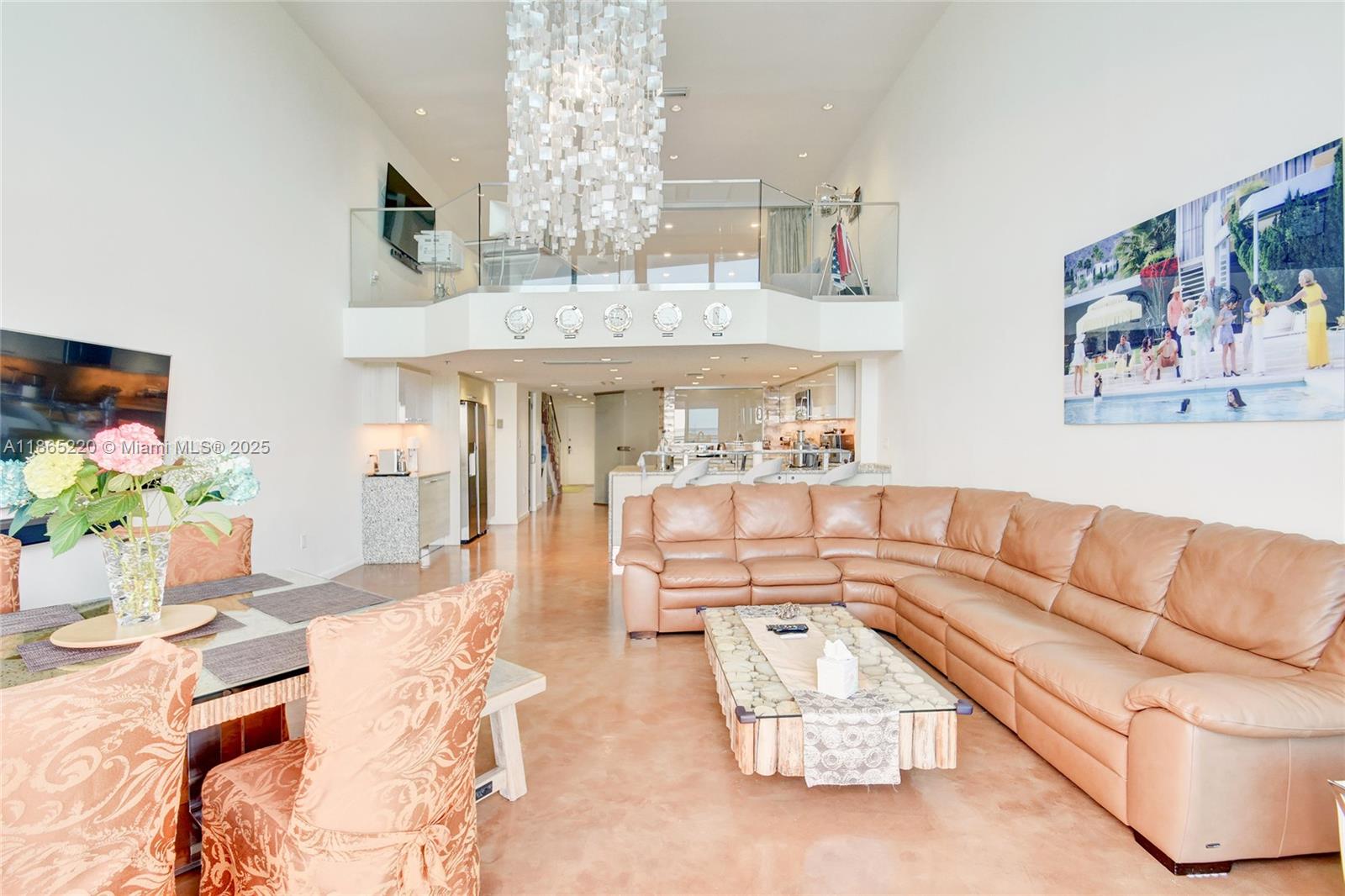 5445 Collins Avenue, Unit P2 Miami Beach, FL 33140 - Photo 9 of 62 a living room with furniture and a chandelier