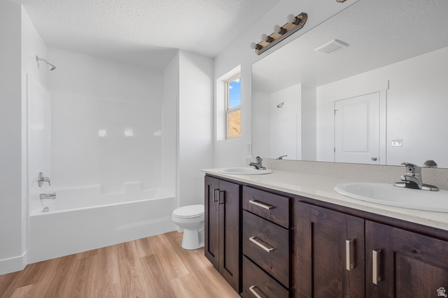 291 North Slant Road, Unit 46M Mapleton, UT 84660 - Photo 16 of 19 Bathroom featuring double vanity, light wood-type flooring, a textured ceiling, and bathing tub / shower combination