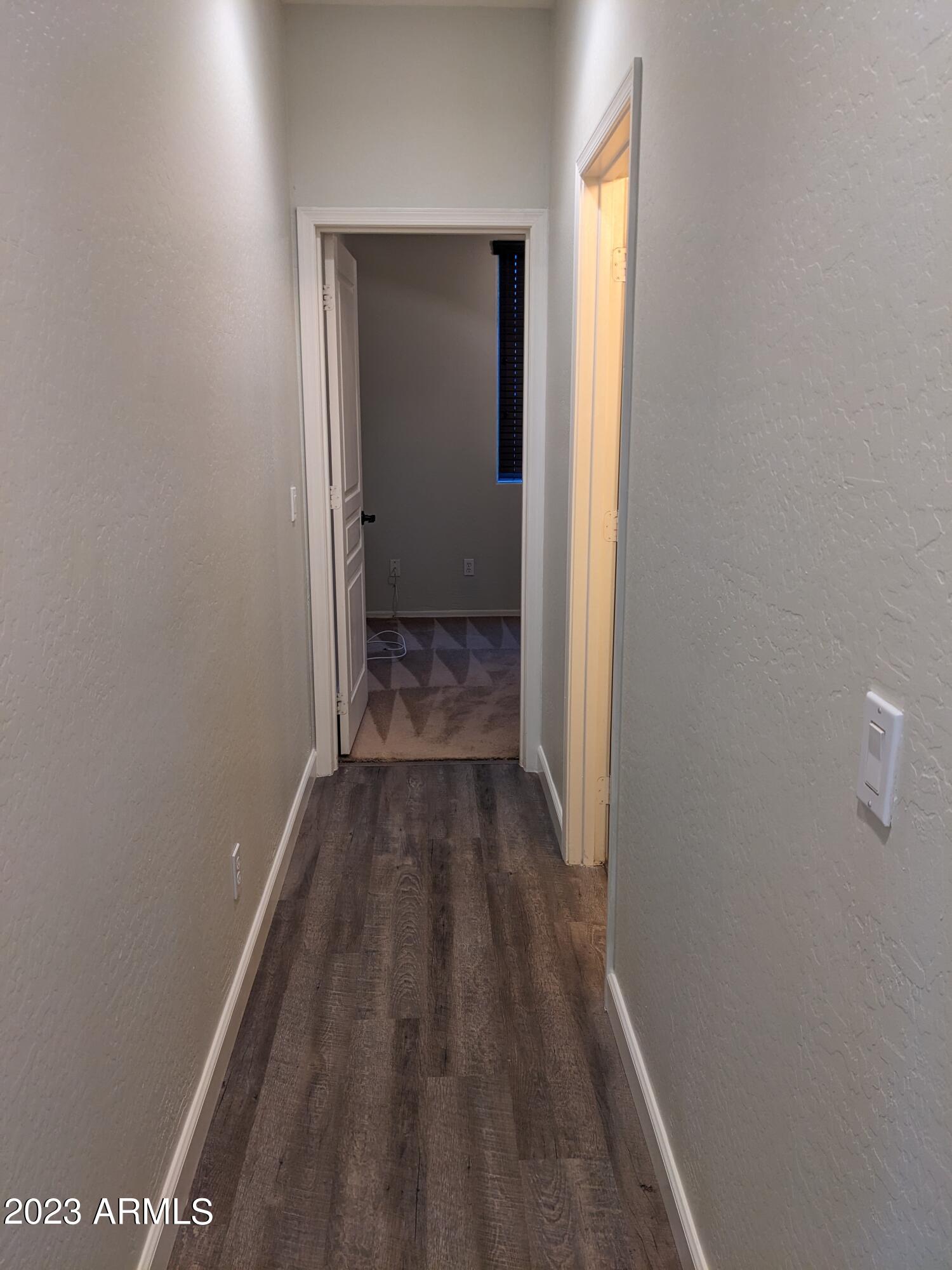 14099 West Riviera Drive Surprise, AZ 85379 - Photo 12 of 27 a view of a room with wooden floor and a window