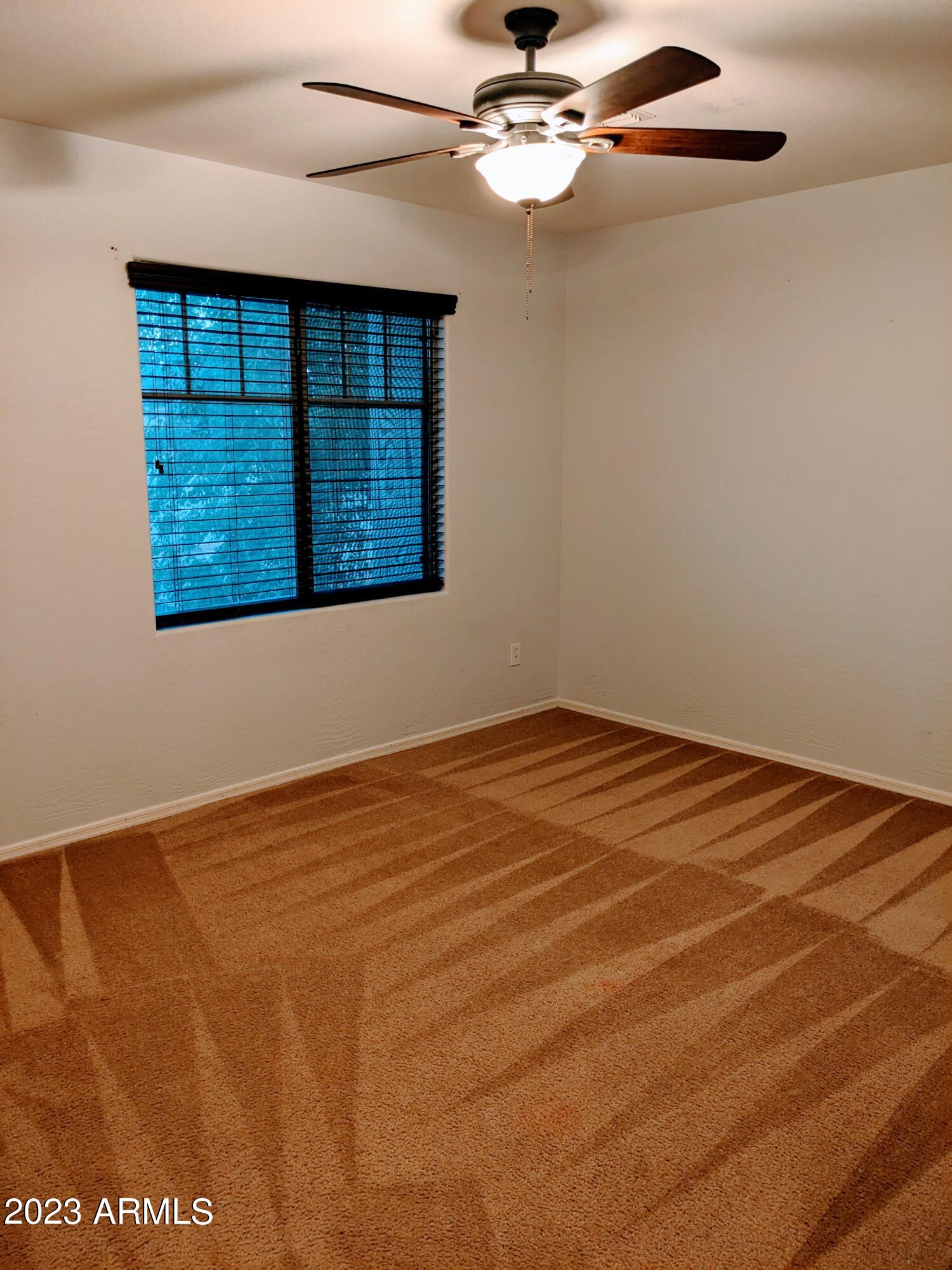 14099 West Riviera Drive Surprise, AZ 85379 - Photo 24 of 27 a view of an empty room with a window