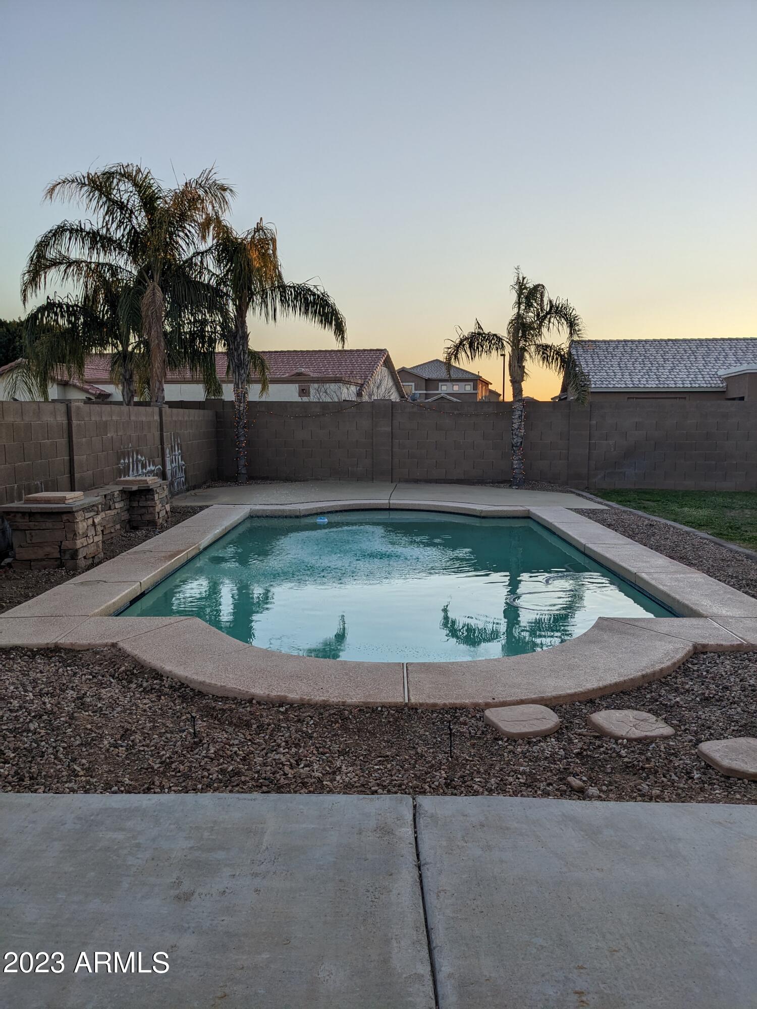 14099 West Riviera Drive Surprise, AZ 85379 - Photo 26 of 27 a view of a house with a yard and potted plants