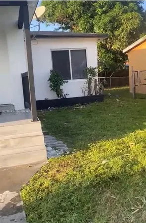 a view of backyard with wooden fence
