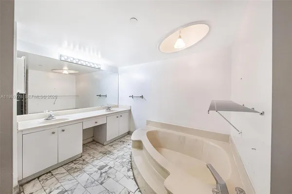 a view of a yard with plants and palm trees