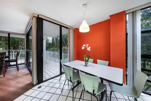 a large kitchen with stainless steel appliances a sink a stove and cabinets