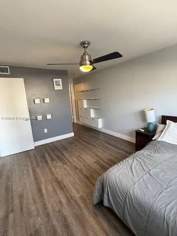 a bedroom with a bed and painting on the wall