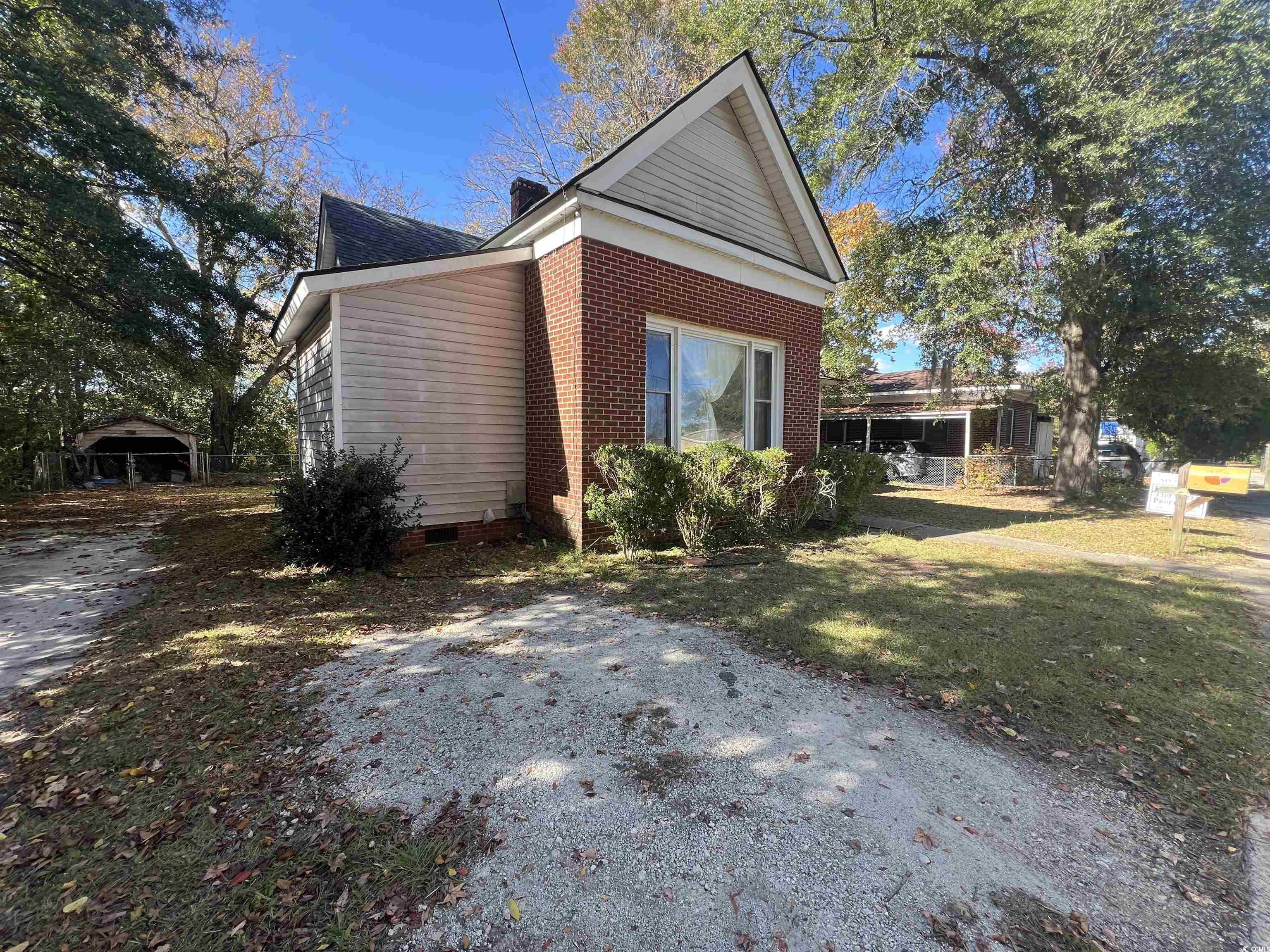 110 Gordon Street Kingstree, SC 29556 - Photo 3 of 8 View of side of property with a chimney, a lawn, and crawl space