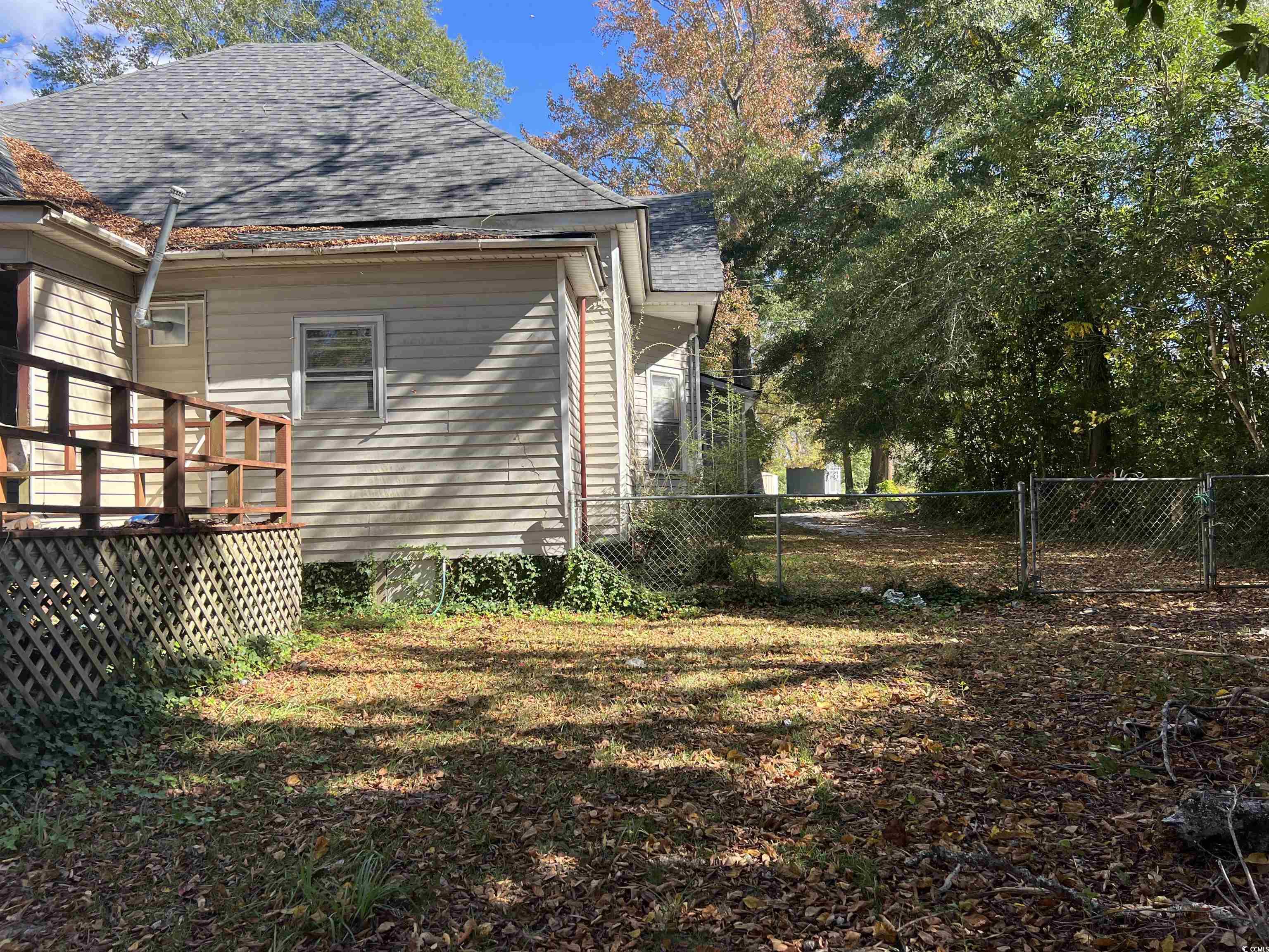 110 Gordon Street Kingstree, SC 29556 - Photo 5 of 8 View of home's exterior featuring roof with shingles and a wooden deck