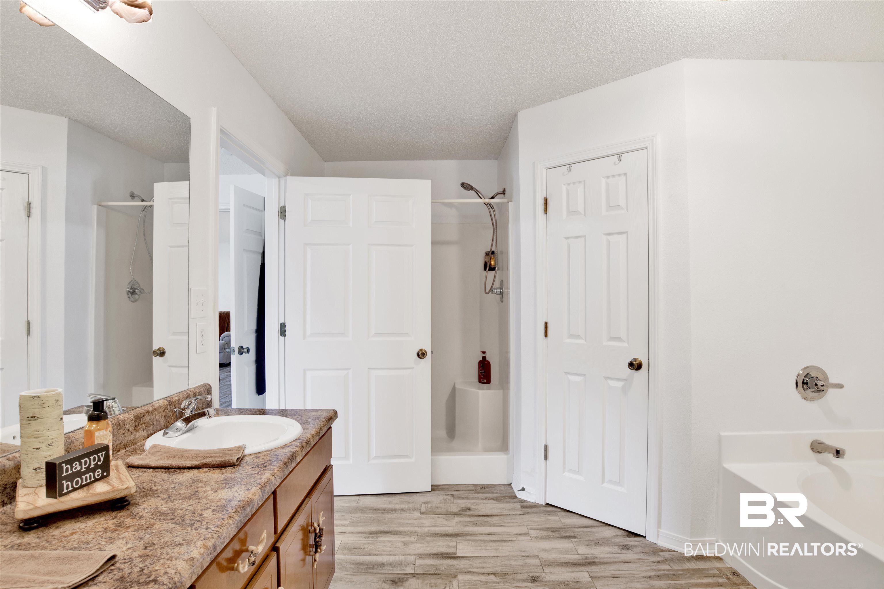 54563 Splinter Hill Road Perdido, AL 36562 - Photo 22 of 29 Bathroom with a textured ceiling, vanity, hardwood / wood-style floors, and independent shower and bath