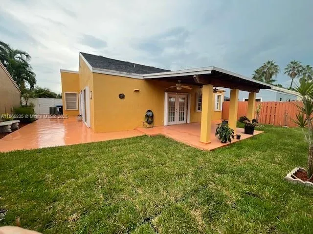 a view of a backyard with plants and a patio