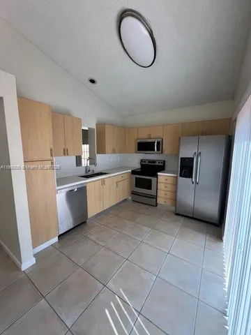 a kitchen with cabinets and appliances
