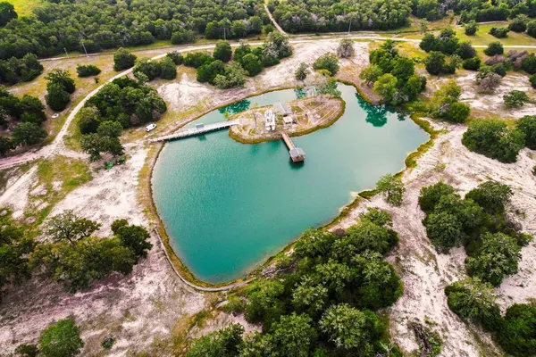 an aerial view of a house with a lake view