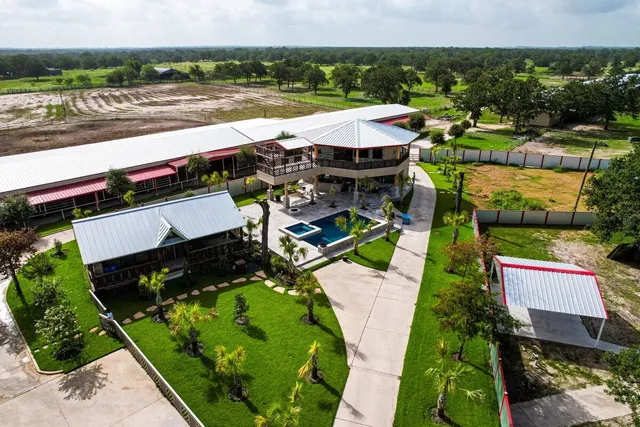 an aerial view of a house with garden space and street view